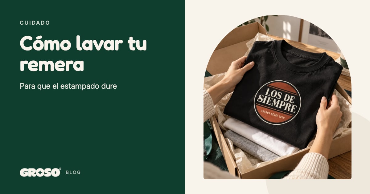 Manos que acomodan en una caja una remera negra estampada con el escudo Los de siempre, sobre una remera blanca y una gris